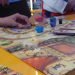 Pengunjung bermain board game didampingi oleh Game Master di Celestia Board Game