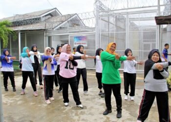 Bengkulu, 27 Desember 2025 – Semangat kebersamaan menyambut pergantian tahun tampak menyala di Lembaga Pemasyarakatan (Lapas) Kelas IIA Bengkulu pada Sabtu pagi. Para Aparatur Sipil Negara (ASN) dan peserta magang tampak antusias mengikuti kegiatan senam pagi bersama warga binaan di lapangan tenis Lapas Bengkulu. Kegiatan yang digelar sebagai bagian dari pembinaan jasmani ini berlangsung penuh energi dan keceriaan. Irama musik senam yang mengalun membuat suasana semakin hidup, sementara deretan peserta dari petugas, peserta magang, hingga warga binaan terlihat kompak mengikuti gerakan instruktur. Tak hanya sebatas aktivitas olahraga, momentum ini juga menjadi ruang interaksi positif antara petugas dan warga binaan dalam nuansa kekeluargaan yang hangat. Meski berada di penghujung tahun, semangat ASN dan peserta magang tetap membara menghadapi tahun baru. Mereka berharap momentum ini menjadi awal dari komitmen bersama untuk menjaga kesehatan, meningkatkan disiplin, serta memperkuat keharmonisan di lingkungan pemasyarakatan. Melalui kegiatan ini, Lapas Bengkulu menunjukkan bahwa pembinaan bukan hanya tentang aturan dan pengawasan, tetapi juga membangun semangat optimisme, saling mendukung, dan menata langkah baru yang lebih baik menuju tahun 2026.