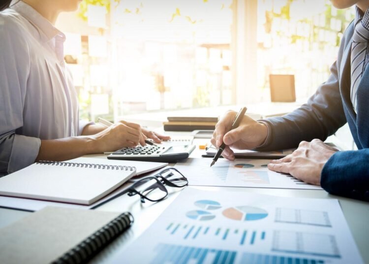 Sumber Daya Terbatas, Target Tak Terbatas: Bagaimana Akuntansi Manajemen Membantu Perusahaan Bekerja Lebih Optimal 5 business man financial inspector and secretary making report, calculating or checking balance. Internal Revenue Service inspector checking document. Audit concept