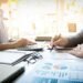 Sumber Daya Terbatas, Target Tak Terbatas: Bagaimana Akuntansi Manajemen Membantu Perusahaan Bekerja Lebih Optimal 17 business man financial inspector and secretary making report, calculating or checking balance. Internal Revenue Service inspector checking document. Audit concept